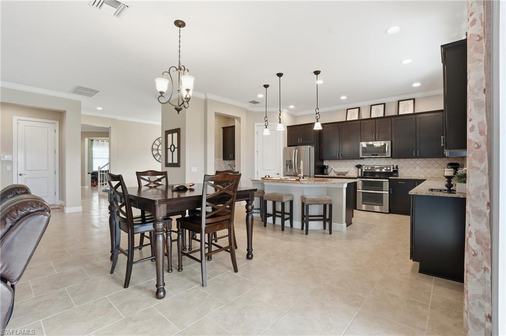 4609 Abaca Circle Naples, FL 34119 - Photo 6 of 49 a large kitchen with a table and chairs