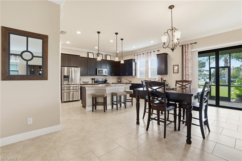 4609 Abaca Circle Naples, FL 34119 - Photo 7 of 49 a large kitchen with a table and chairs