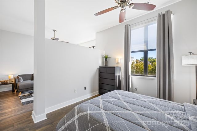 a bedroom with a bed and a chair