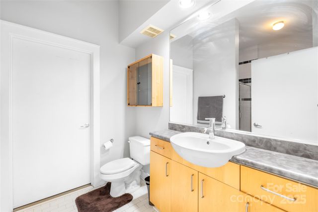 a bathroom with a sink toilet and a mirror