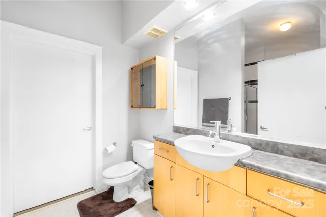 a bathroom with a sink toilet and a mirror