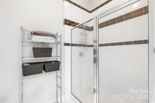 a bathroom with a shower and a sink