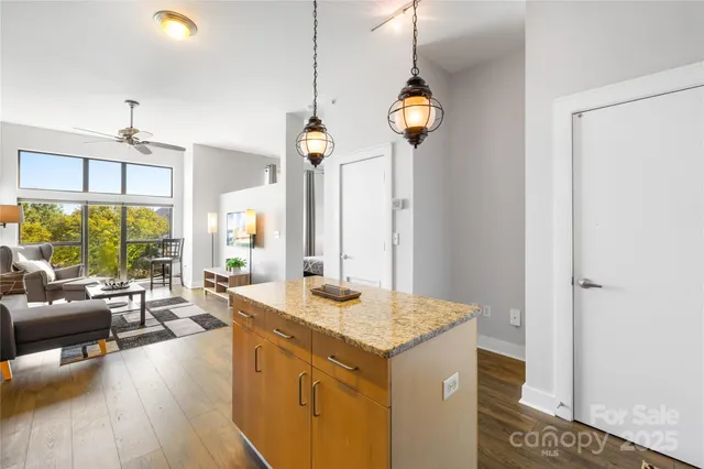 a view of living room with granite countertop furniture and a chandelier