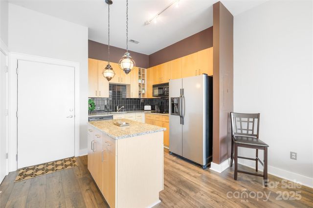 a open kitchen with a refrigerator a sink and a stove