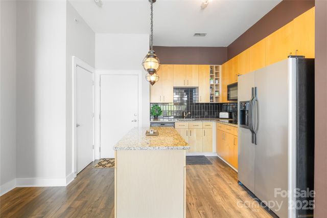 a view of a kitchen with a refrigerator and a stove