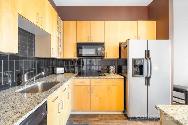 a kitchen with a refrigerator a sink and a counter