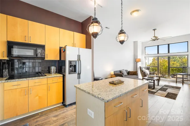 a kitchen with a sink a counter top space appliances and cabinets
