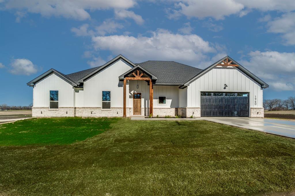 1960 Newton Road Ferris, TX 75125 - Photo 1 of 1 Modern farmhouse style home with a front yard, brick siding, and board and batten siding