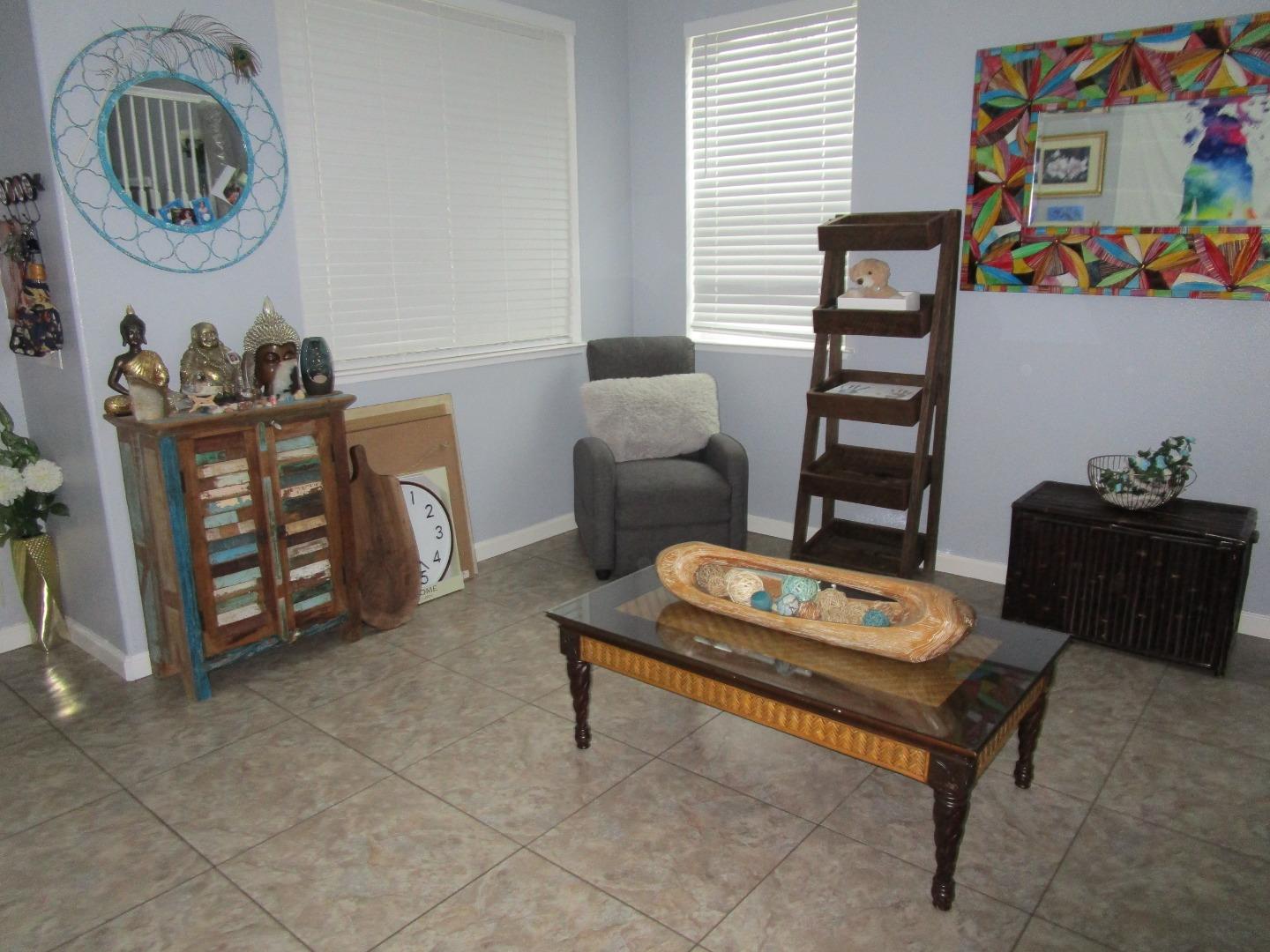 413 Hydrangea Court Merced, CA 95341 - Photo 7 of 16 a living room with furniture a rug and a window