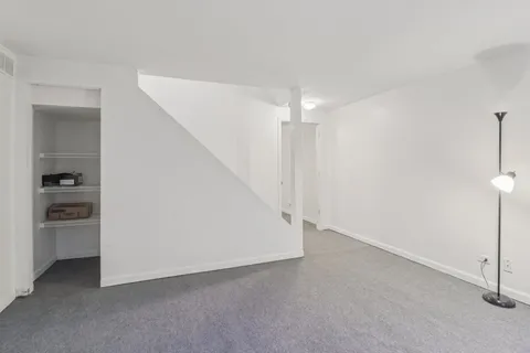 a view of an empty room with a kitchen