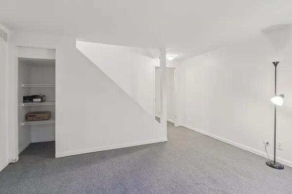 a view of an empty room with a kitchen