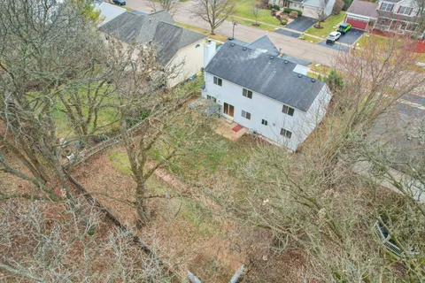 a white house with a tree in the background