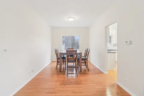 a dining room with furniture and wooden floor
