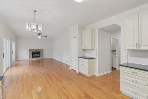 a view of a kitchen with wooden floor and a kitchen