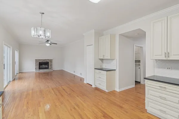 a view of a kitchen with wooden floor and a kitchen