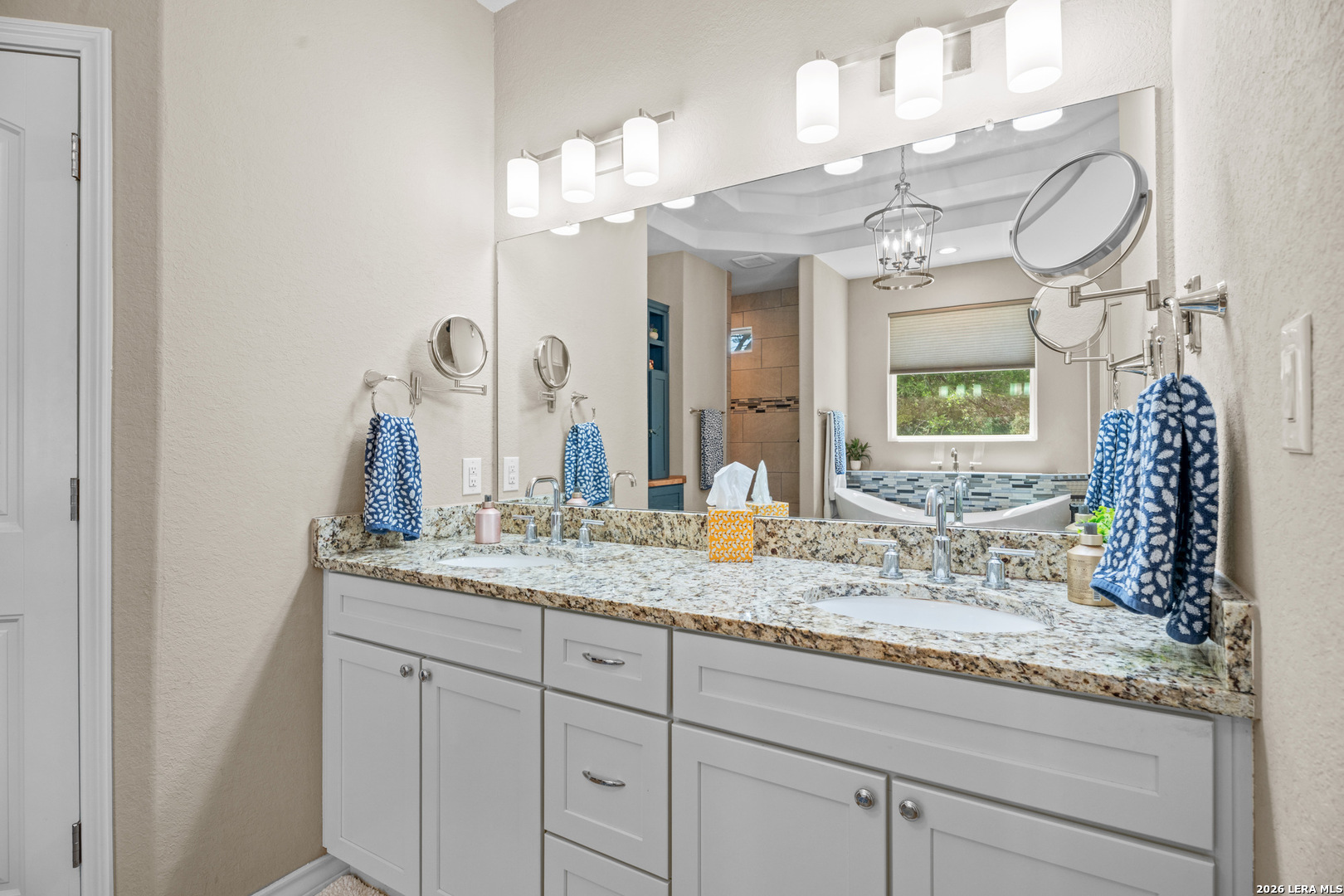 819 Primrose Path Spring Branch, TX 78070 - Photo 10 of 17 a bathroom with a granite countertop double vanity sink and a mirror