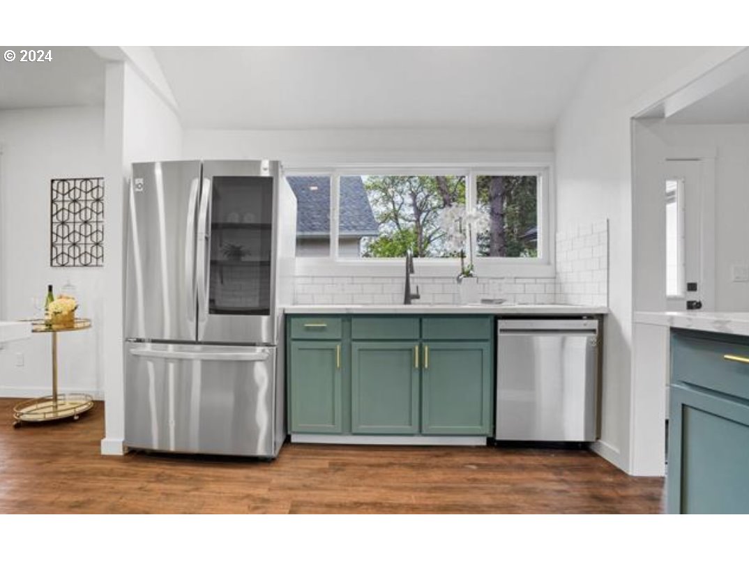 4840 Herrin Road Northeast Salem, OR 97305 - Photo 3 of 23 a kitchen with stainless steel appliances granite countertop a refrigerator and a sink