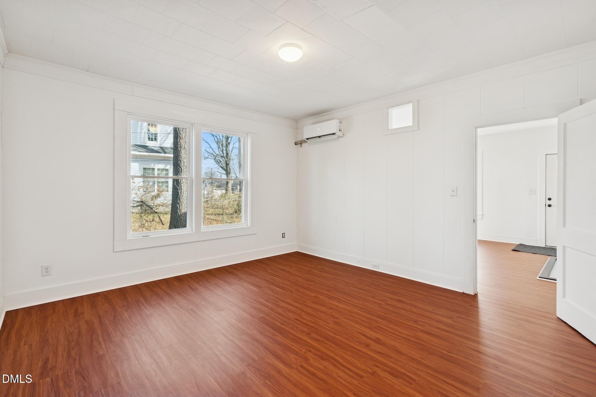 705 North Driver Street Durham, NC 27703 - Photo 14 of 46 an empty room with wooden floor and windows