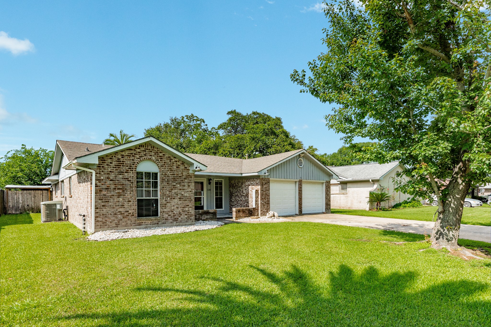 128 Houston Street Angleton, TX 77515 - Photo 2 of 25 a front view of house with yard and green space