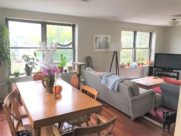 a living room with furniture and a large window