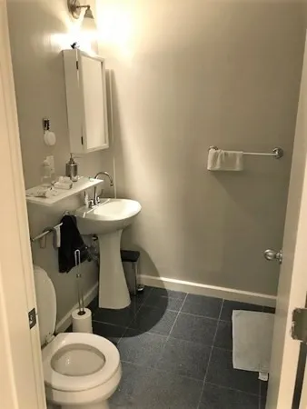 a bathroom with a toilet sink and mirror