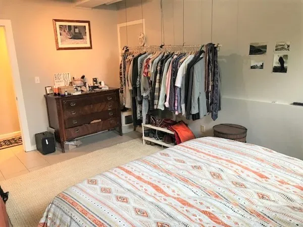 a bedroom with a bed and a walk in closet