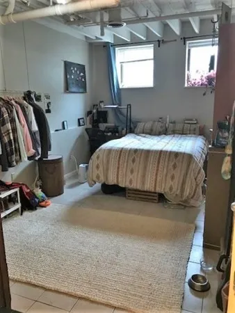 a bed room with a bed window and a chair