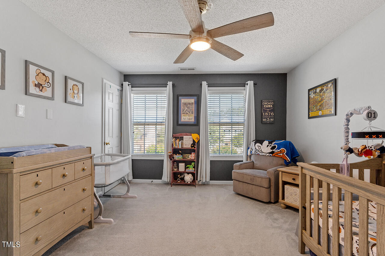 689 Seastone Street Raleigh, NC 27603 - Photo 18 of 34 a bedroom with furniture and a window