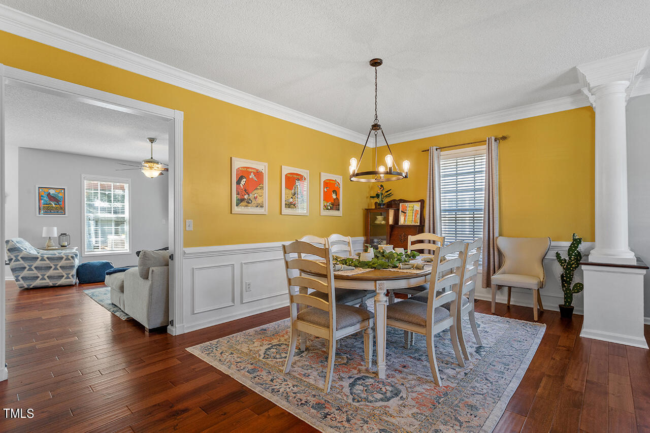 689 Seastone Street Raleigh, NC 27603 - Photo 4 of 34 a view of a dining room with furniture window and wooden floor