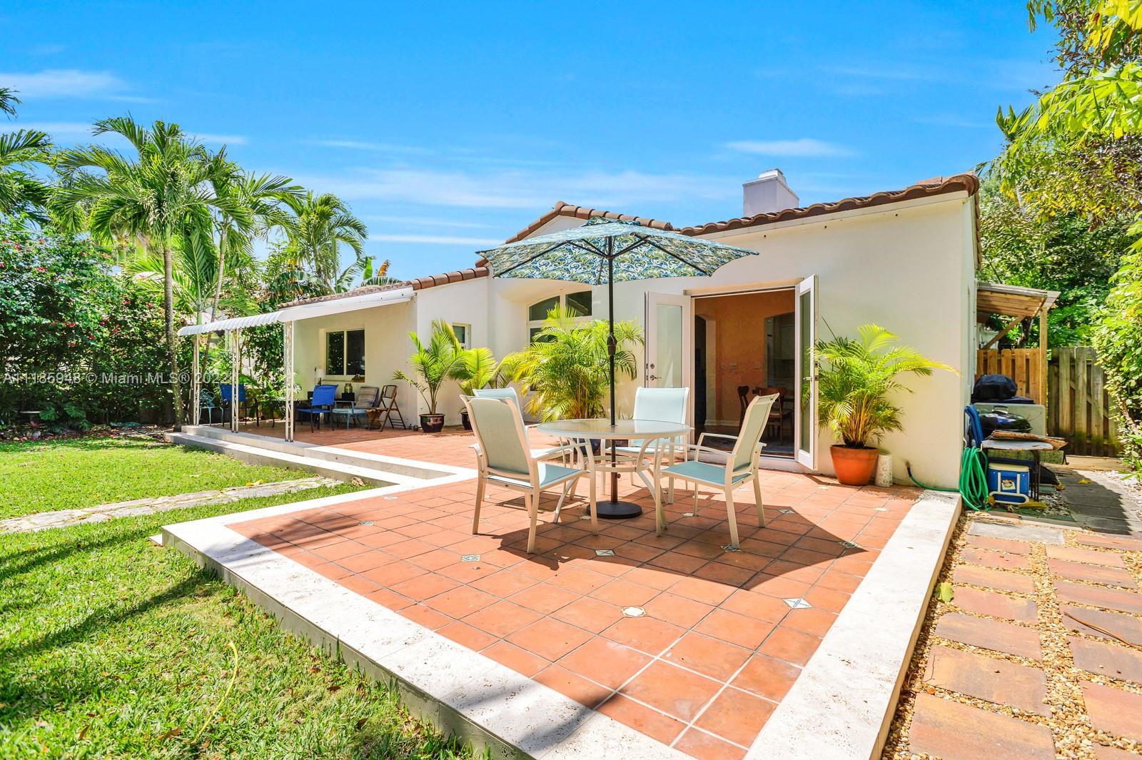 5429 Alton Road Miami Beach, FL 33140 - Photo 15 of 20 a view of a patio with couches table and chairs and potted plants
