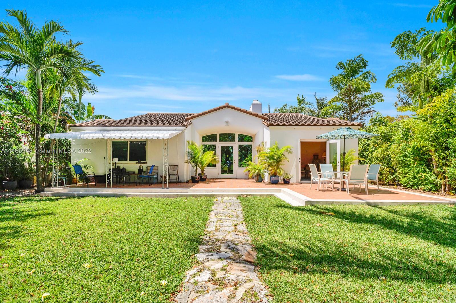 5429 Alton Road Miami Beach, FL 33140 - Photo 18 of 20 a front view of a house with swimming pool having outdoor seating