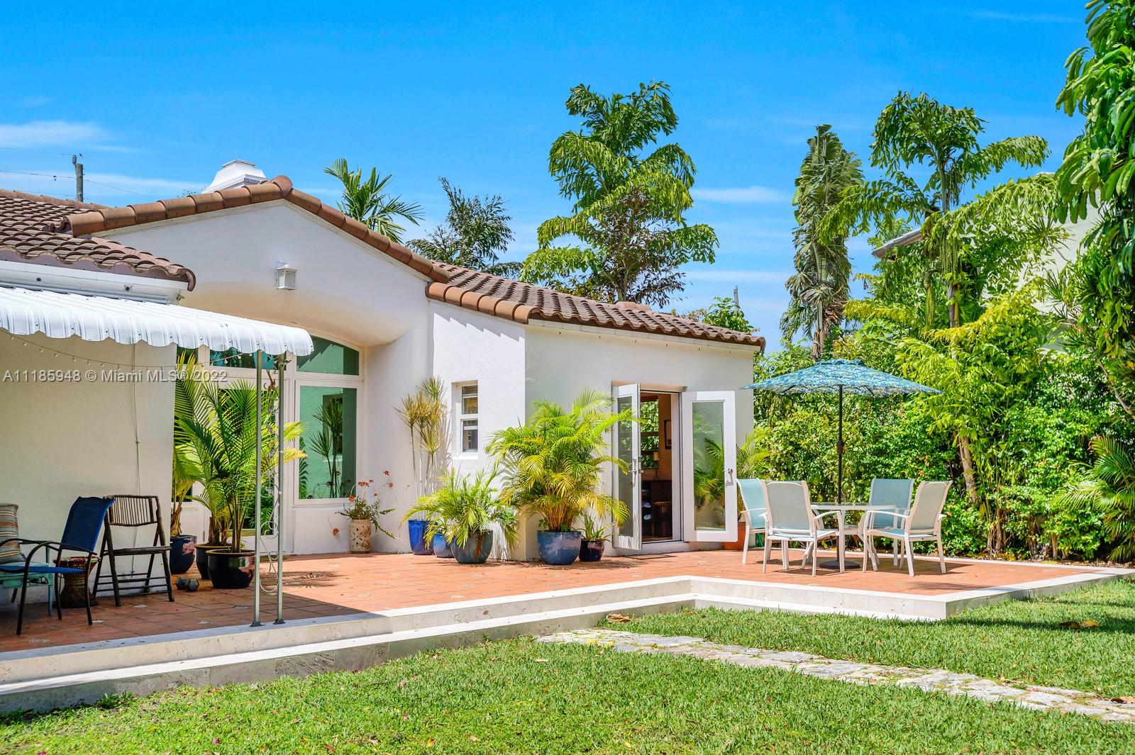 5429 Alton Road Miami Beach, FL 33140 - Photo 5 of 20 a view of a patio with table and chairs and potted plants