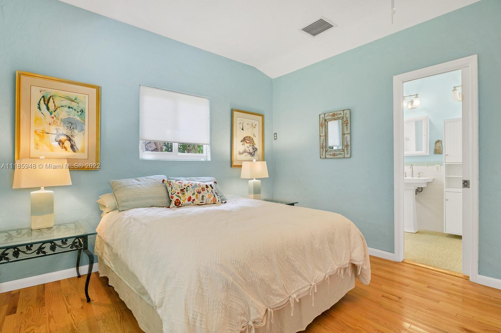 5429 Alton Road Miami Beach, FL 33140 - Photo 9 of 20 a bedroom with a bed and wooden floor