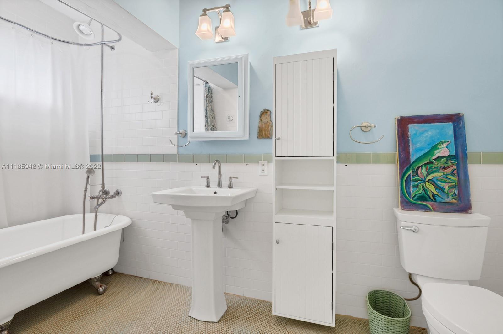 5429 Alton Road Miami Beach, FL 33140 - Photo 10 of 20 a bathroom with a sink a toilet and shower