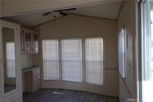 a view of empty room with wooden floor