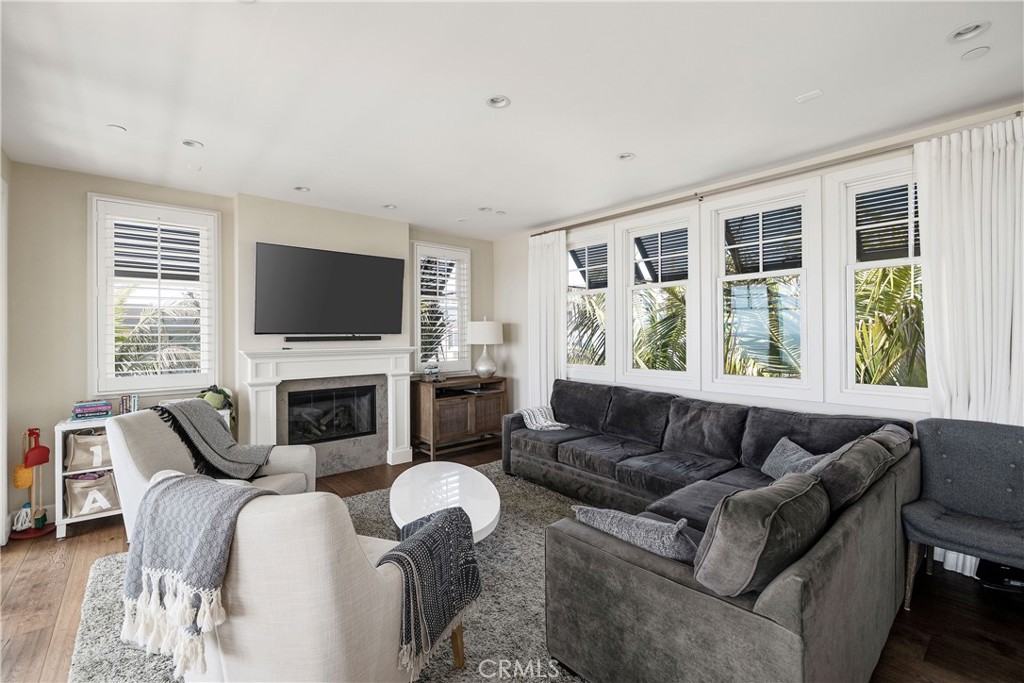 124 23rd Street Manhattan Beach, CA 90266 - Photo 12 of 50 a living room with furniture a flat screen tv and a fireplace