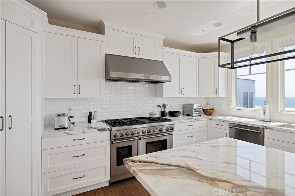124 23rd Street Manhattan Beach, CA 90266 - Photo 16 of 50 a kitchen with granite countertop a sink stainless steel appliances and cabinets