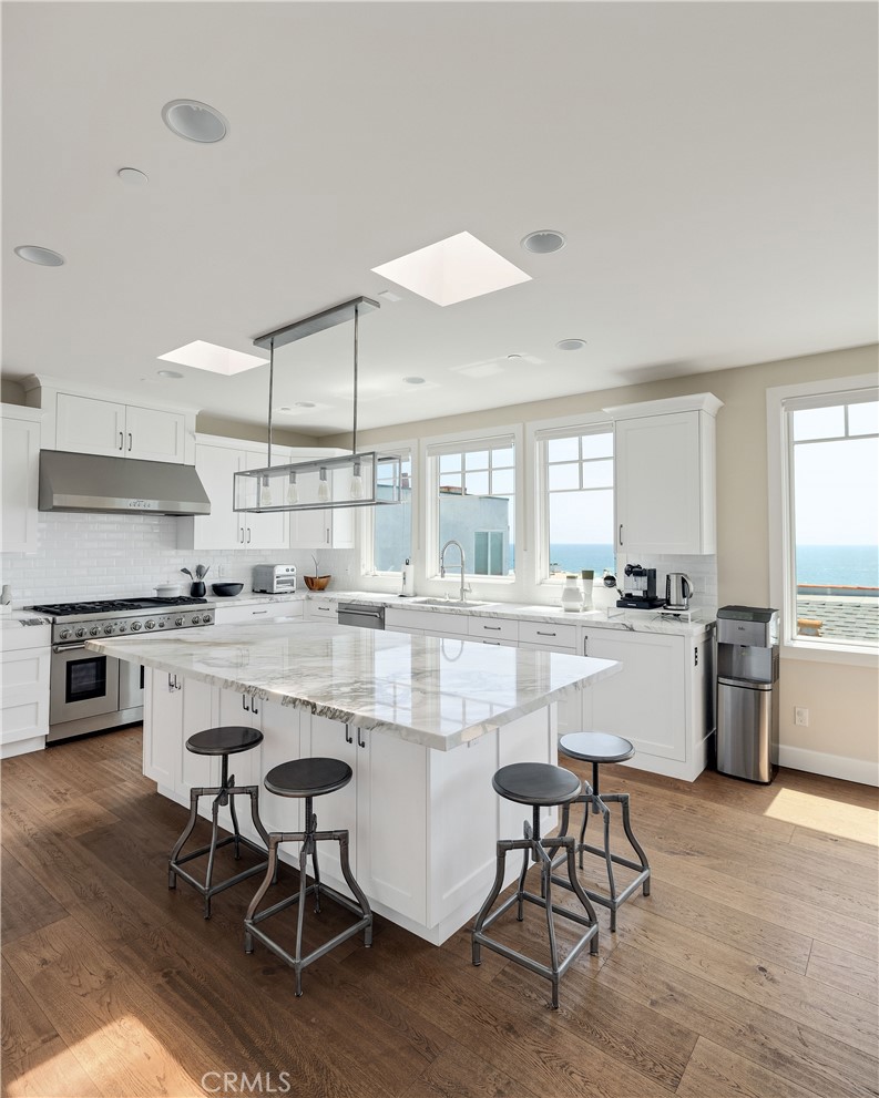 124 23rd Street Manhattan Beach, CA 90266 - Photo 19 of 50 a kitchen with kitchen island granite countertop lots of counter top space and stainless steel appliances