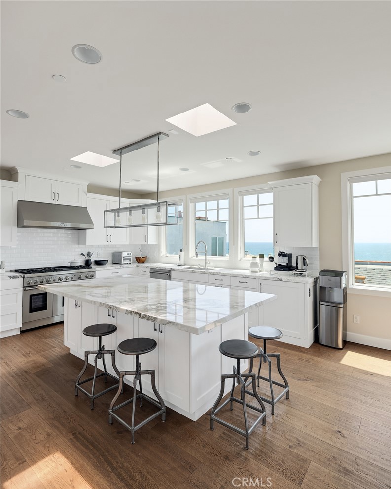 124 23rd Street Manhattan Beach, CA 90266 - Photo 20 of 50 a kitchen with kitchen island granite countertop lots of counter top space and stainless steel appliances