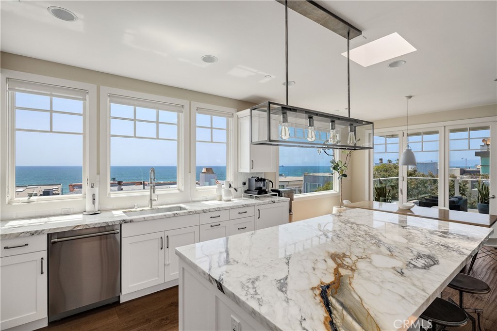 124 23rd Street Manhattan Beach, CA 90266 - Photo 4 of 50 a large kitchen with kitchen island a large counter space windows and appliances