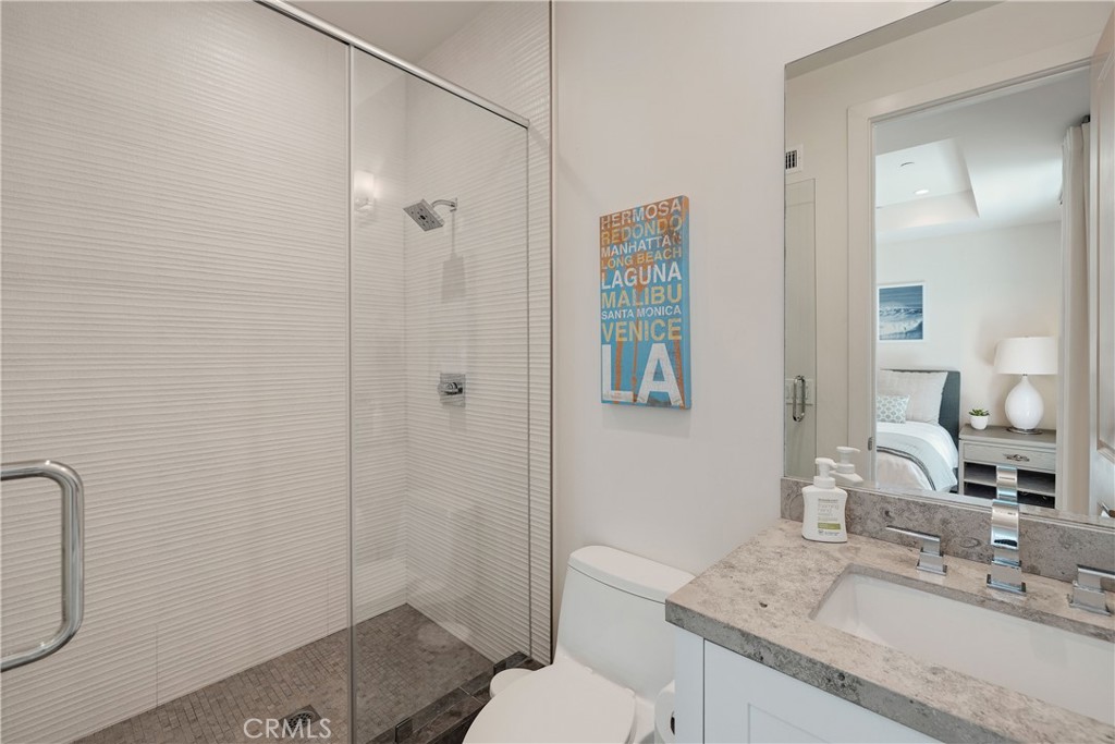 124 23rd Street Manhattan Beach, CA 90266 - Photo 48 of 50 a bathroom with a granite countertop sink a toilet and shower