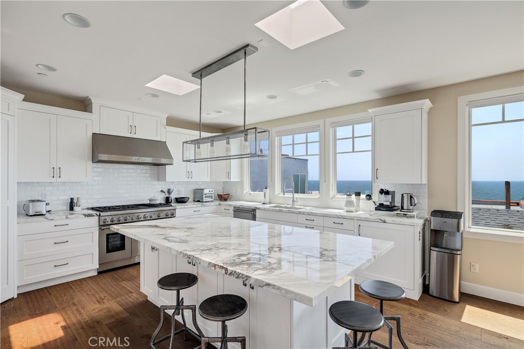 124 23rd Street Manhattan Beach, CA 90266 - Photo 5 of 50 a kitchen with a stove a sink and a refrigerator