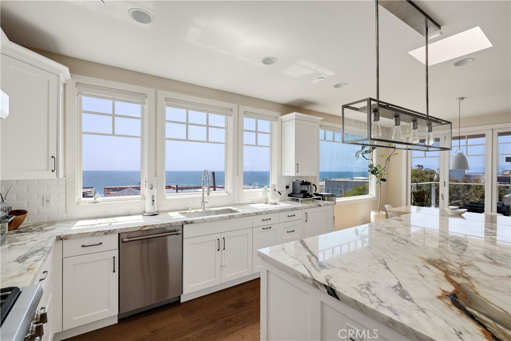124 23rd Street Manhattan Beach, CA 90266 - Photo 8 of 50 a kitchen with stainless steel appliances granite countertop a sink cabinets and wooden floor