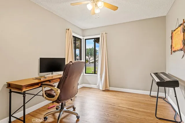 a view of a workspace with furniture and a window