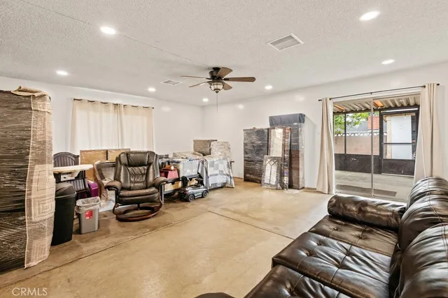 a living room with furniture gym equipment and a large window