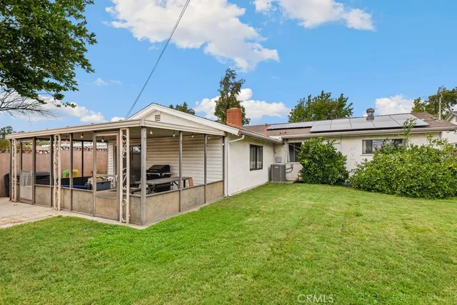 a view of a house with backyard and porch
