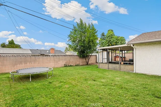 a swimming pool with outdoor seating and yard