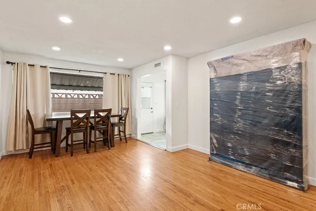 a view of a room with furniture and wooden floor