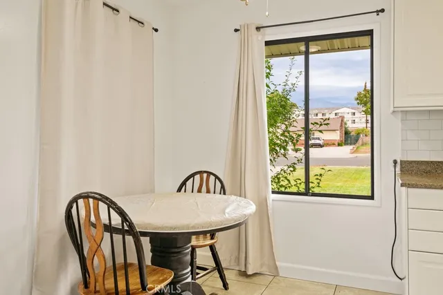 a view of a balcony furniture and a window