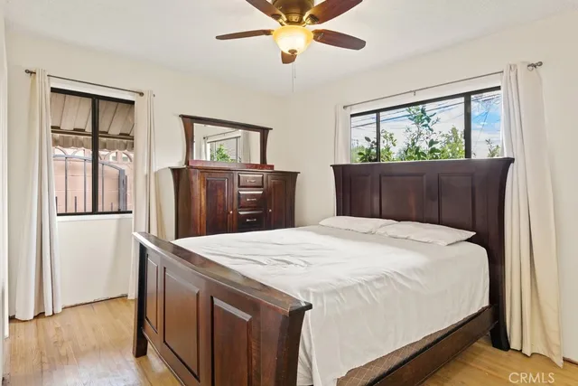a bedroom with a bed and wooden floor
